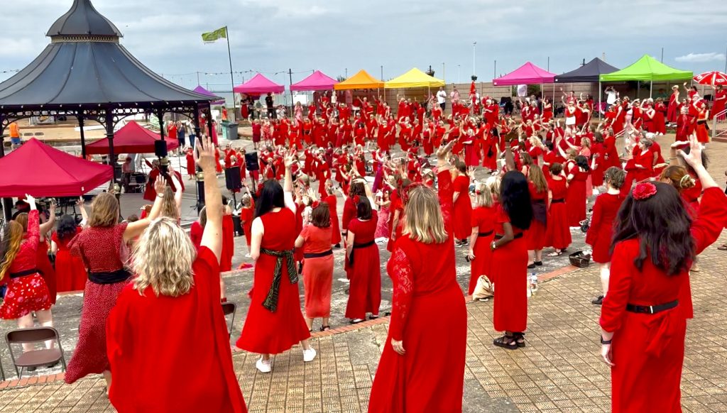 The Most Wuthering Heights Day Ever dancers in red at The Oval Bandstand in Margate